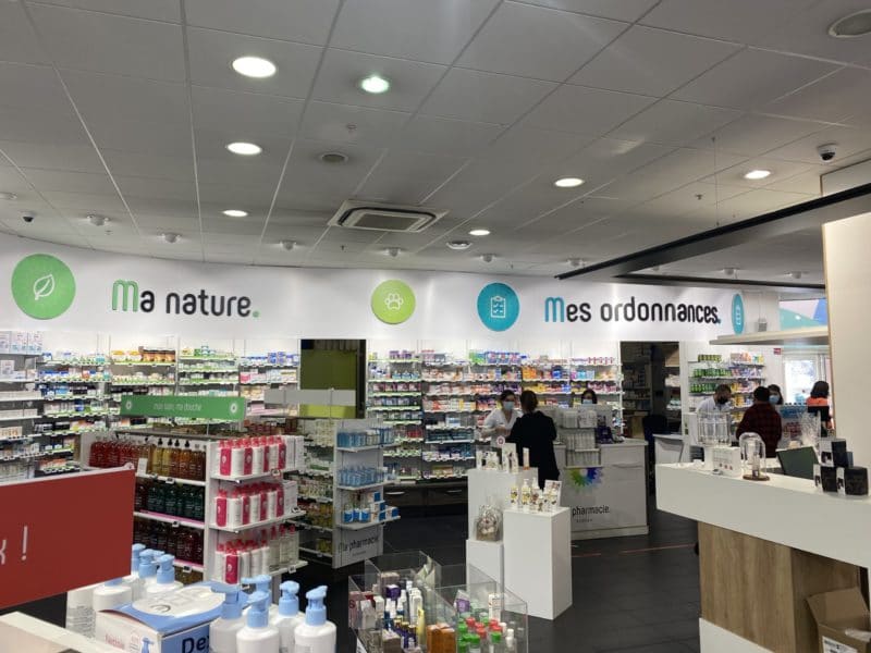Signalétique intérieure de pharmacie à Toulouse avec bandeaux directionnels « Ma nature » et « Mes ordonnances »